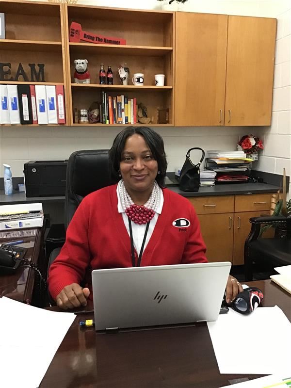 Mrs. Peek sitting at her desk.